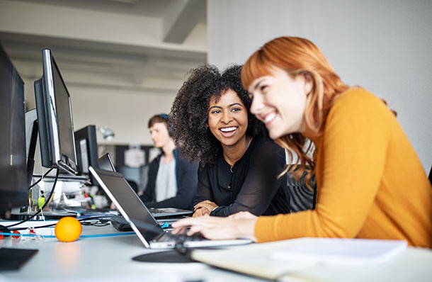 Two women looking at a laptop